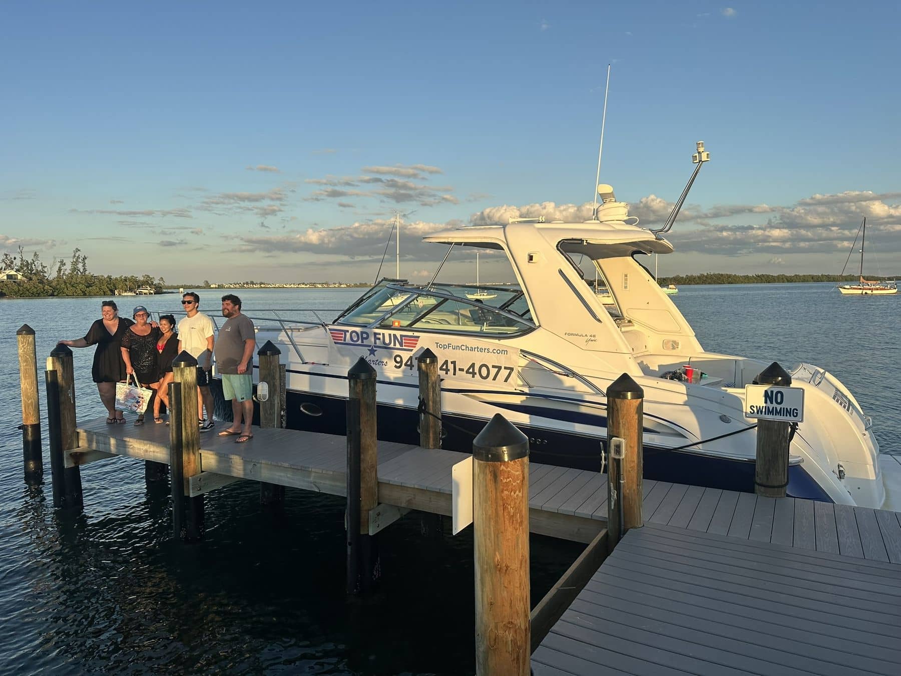 Guests enjoying a private charter aboard Top Fun near Anna Maria Island