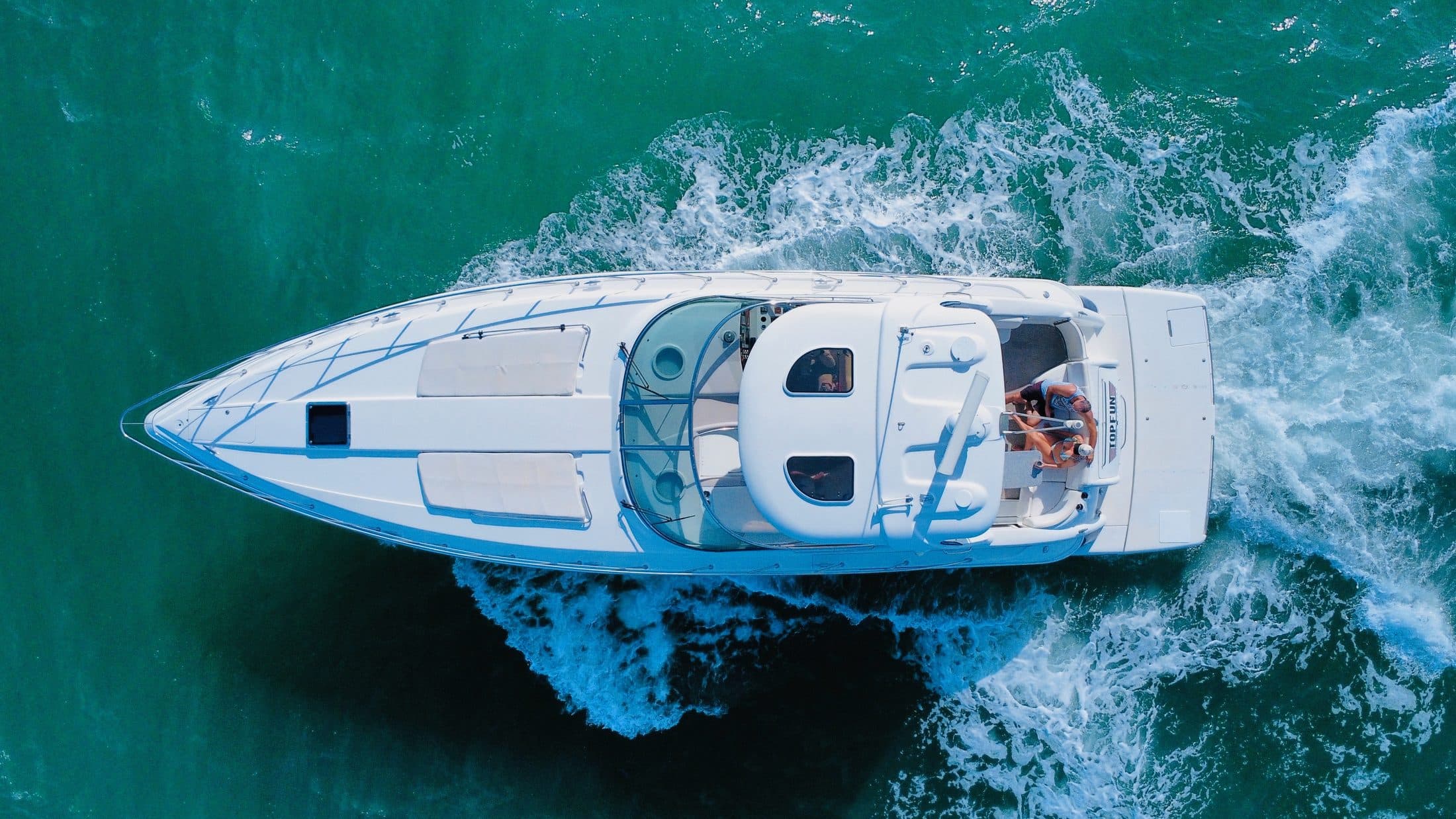 Top Fun yacht anchored at a turquoise sandbar off Anna Maria Island